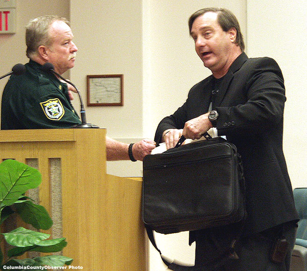 Deputy Hatcher grabs Brown's sleeve