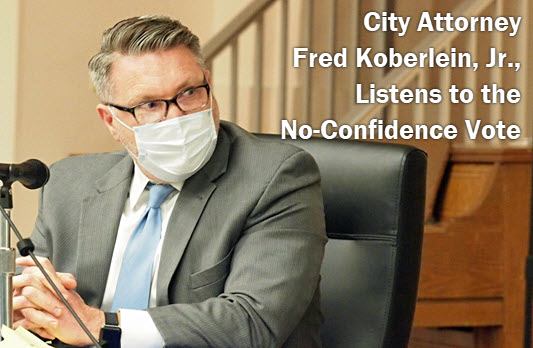 Photo of Lake City Attorney Fred Koberlein with copy: City Attorney Fred Koberlein, Jr., Listens to the no-confidence vote.
