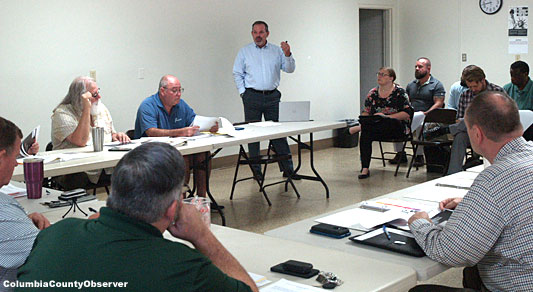 Mr. Jewett (standing) made his presentation to 4 EDAB board members and a handful of government officials in the audience, which included the County's mainstream print media.