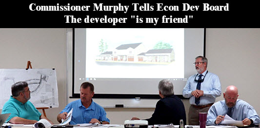 Developer Tim Williams (standing) makes his presentation. Seated: (left to right) Asst. Cnty Manager David Kraus, Chairman Murphy, Econ Dev Dir Glenn Hunter, Cnty Attorney Joel Foreman.