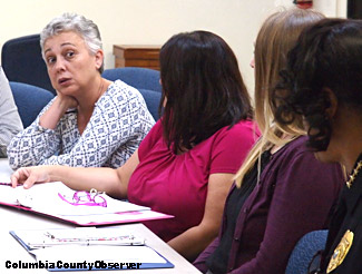 Teresa Pinto listens to Police Chief Gilmore