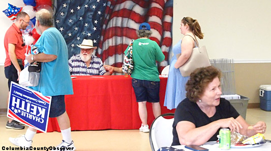 Charlie Keith's election kickoff with man leaving with lawn sign