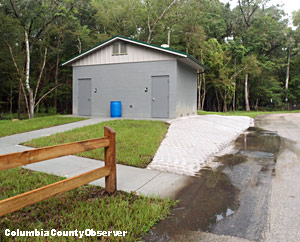 Rain water pools up in front of the handicapped ramp leading to the restrooms.