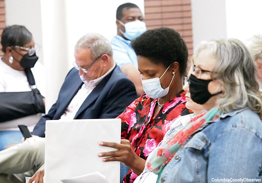 Befaithful Coker straightens her papers as she preparse to leave the Council Chambers