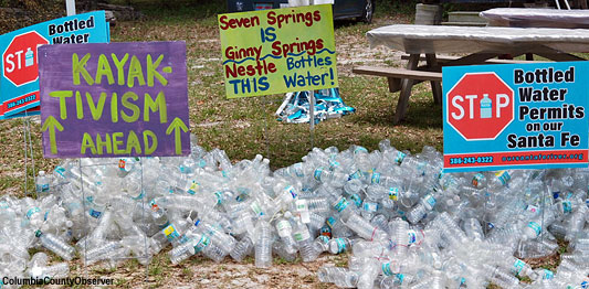 kayaktivism signs and empty plastic bottles