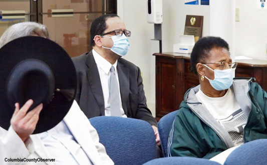 Thomas Thomas (middle) views the City Council in action. Holding his hat to block his face, as usual, Shawn Holmgren and to the right, Betty Jefferson.