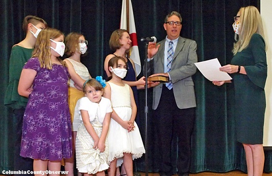 Todd Sampson takes his oath of office surrounded by his family