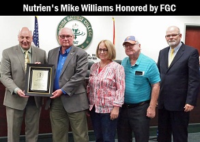 Mike Williams (second from left) with President Barrett, wife Laurie, Uncle Johnny, and Board President William Crawford.