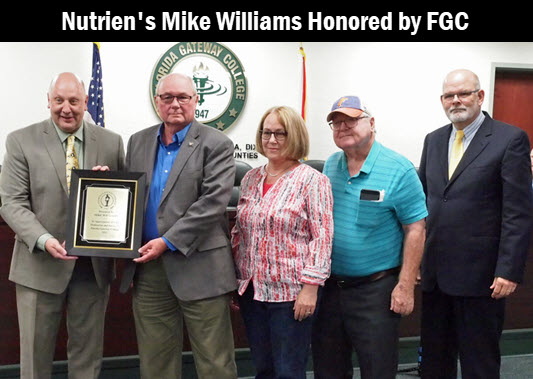 Mike Williams (second from left) with President Barrett, wife Laurie, Uncle Johnny, and Board President William Crawford.