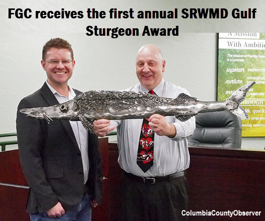 FGC President Dr. Larry Barrett (holding sturgeon) and SRWMD's Troy Roberts